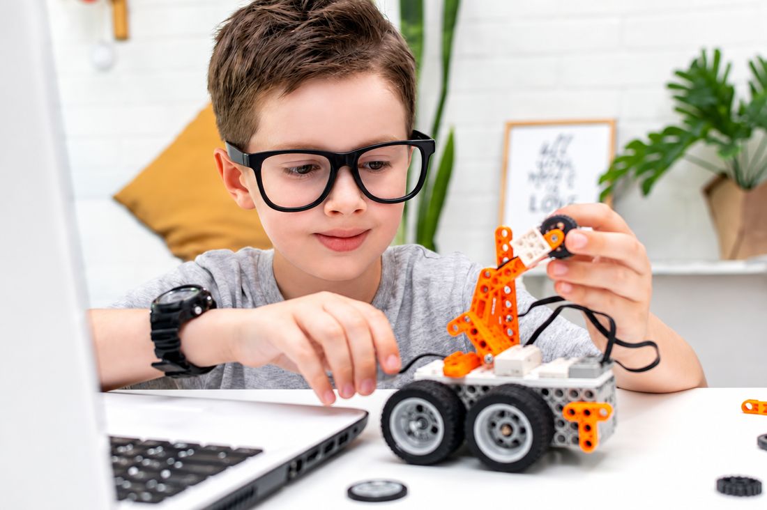Student building a robot car