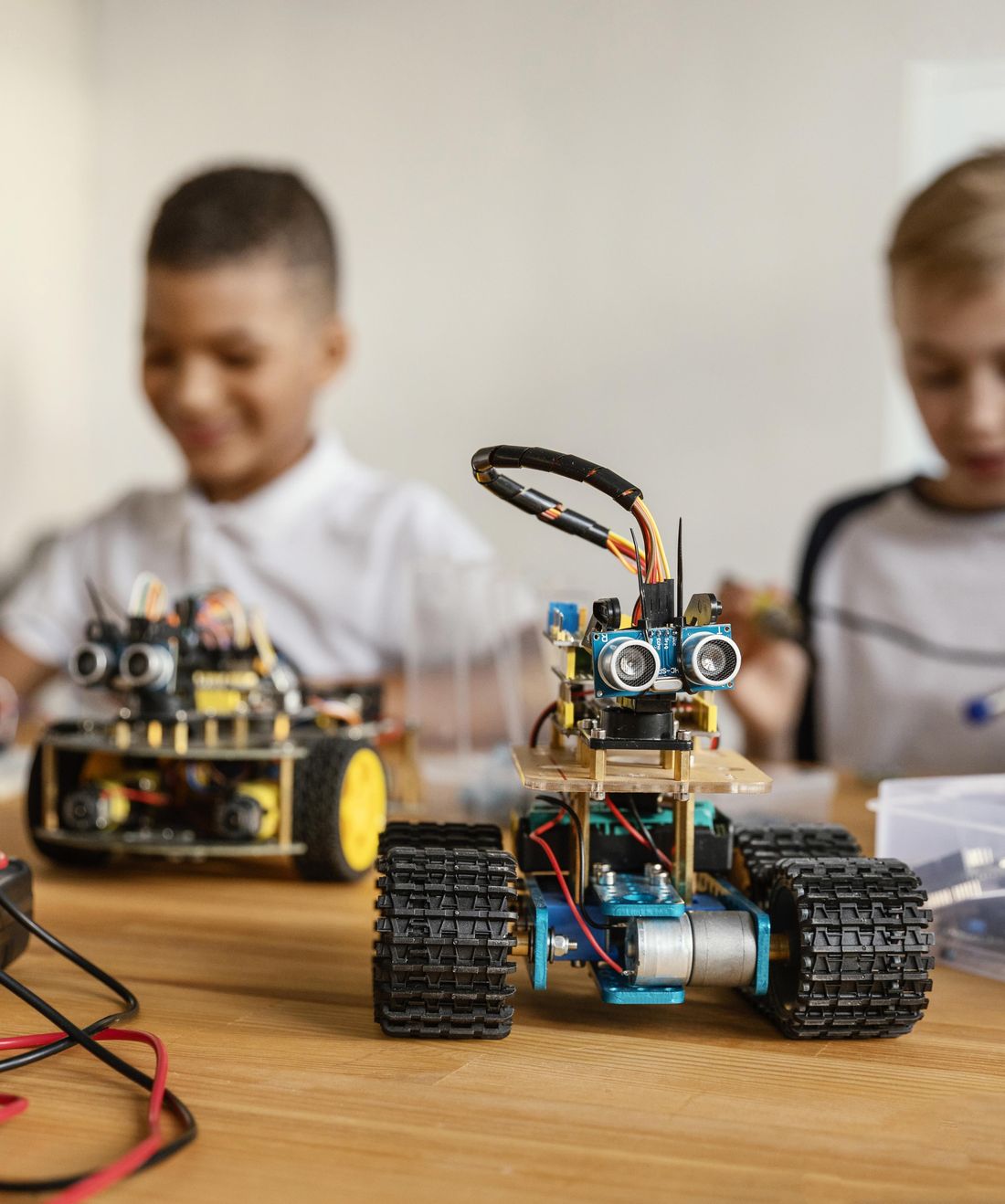 Student with a tracked robot he built